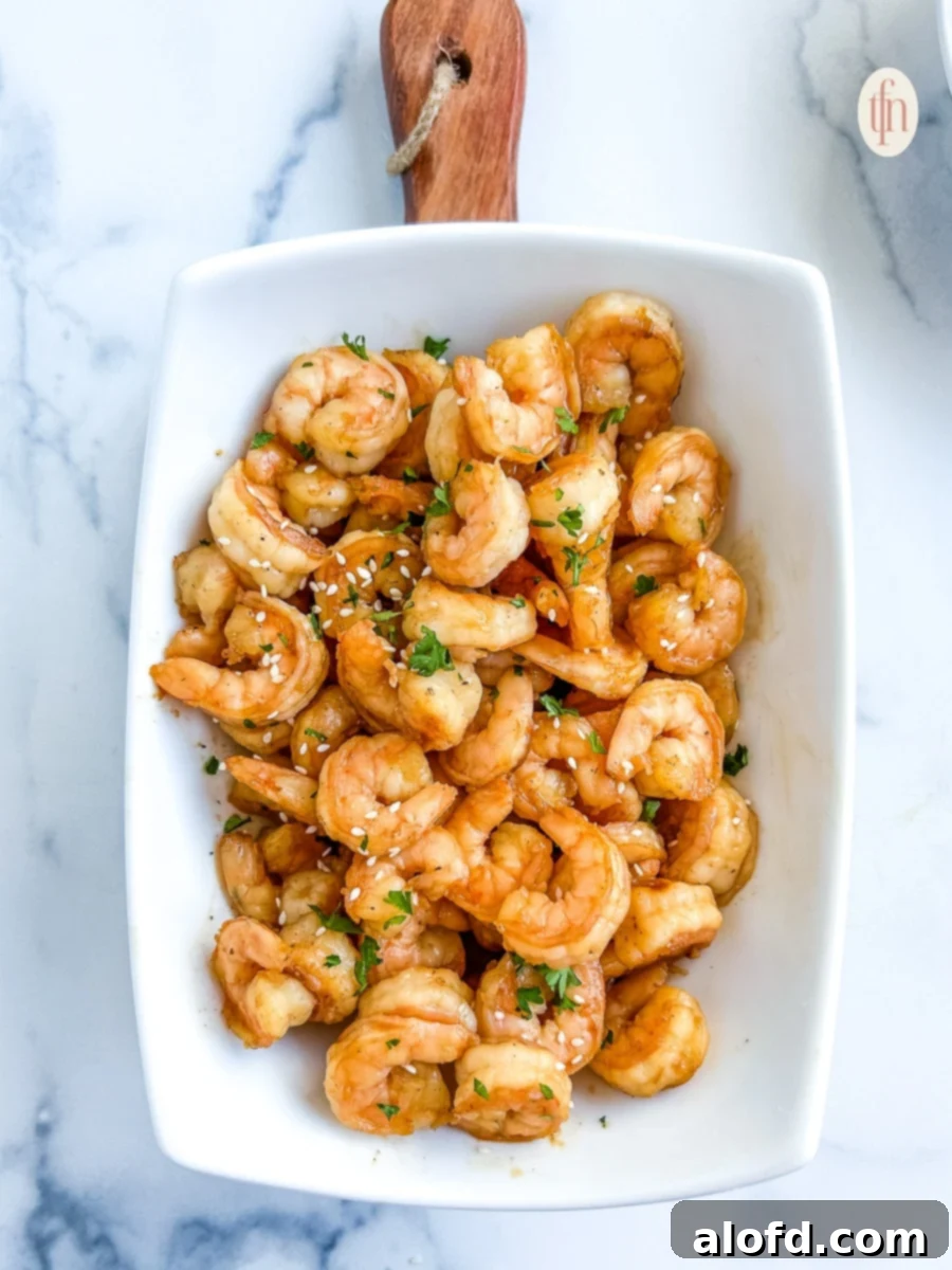 Sun-Kissed Suppers Made Simple 4 Blackstone hibachi shrimp artfully arranged on a white platter, ready to be served.