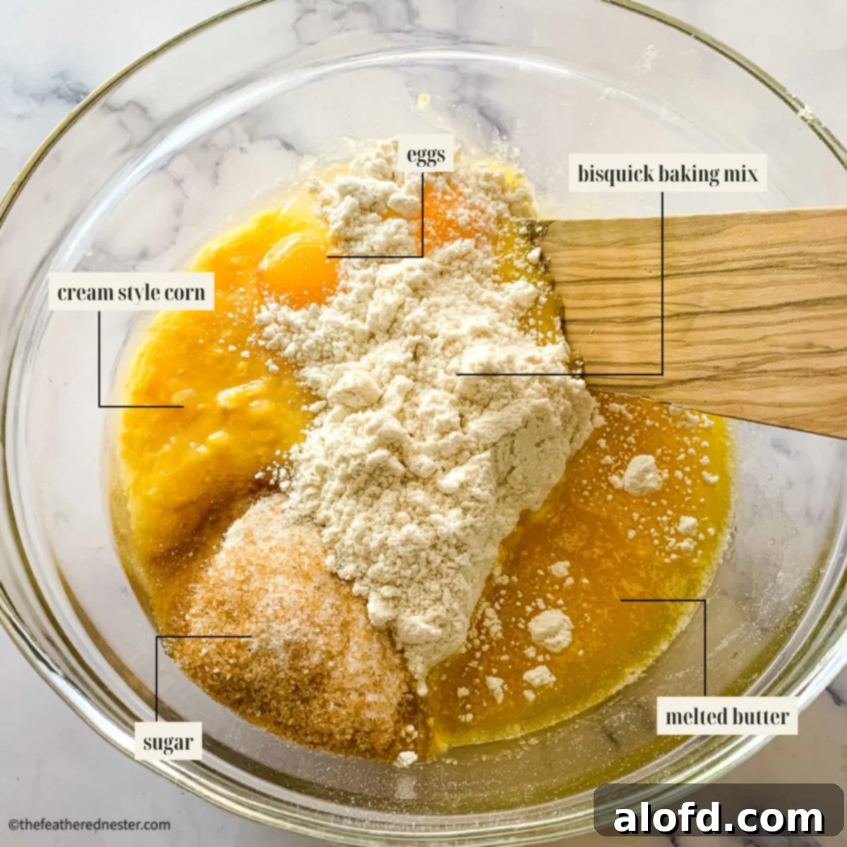 Bisquick Cornbread No Cornmeal Needed 3 Labeled ingredient image for cornbread without cornmeal recipe, showing Bisquick, sugar, butter, creamed corn, and eggs.