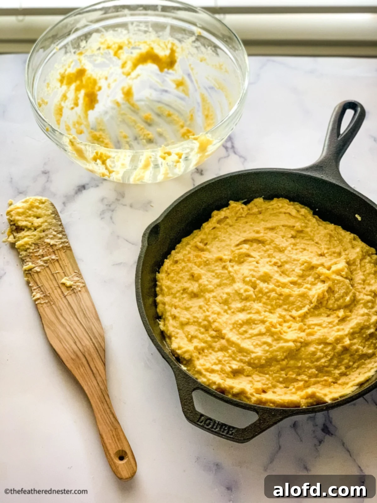 Bisquick Cornbread No Cornmeal Needed 6 Unbaked Bisquick cornbread batter in a cast iron skillet, ready for the oven.