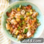 Blackstone Dinners Made Simple 11 A vibrant green bowl filled with delicious Blackstone Chicken Fried Rice, perfectly prepared and ready to be enjoyed.