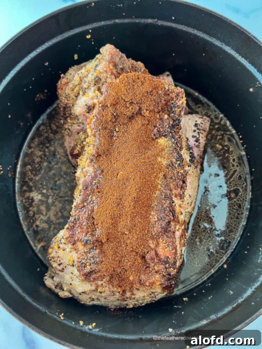 Mexican spices rubbed onto boneless pork shoulder for carnitas recipe.