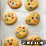 Colorful M&M Cookies fresh off the oven on a baking sheet.