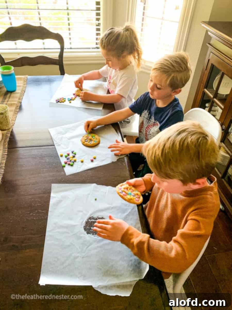 Two children happily making M&M cookies, a fun activity for back to school.