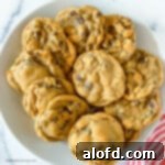 A square photo of a white plate full of delicious no brown sugar chocolate chip cookies.