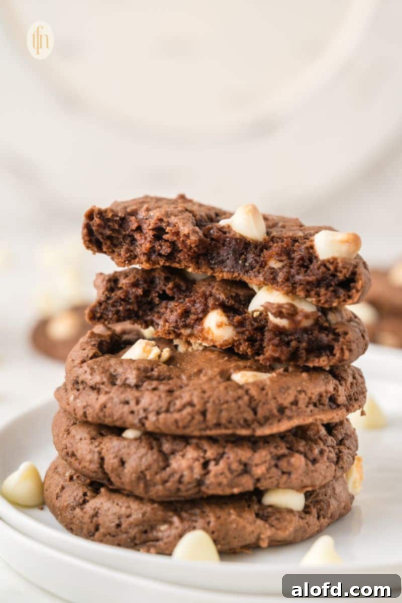 A perfectly stacked pile of rich chocolate cookies, inviting and delicious.