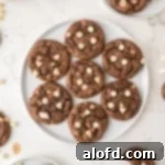 Rich chocolate cookies with white chocolate chips on a round plate.