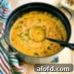 Harvest Bowls and Loaves 11 Ladle in a large pot of homemade cheeseburger soup.