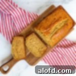 Harvest Bowls and Loaves 21 sliced self rising flour banana bread on a wooden board with a red and white kitchen towel.