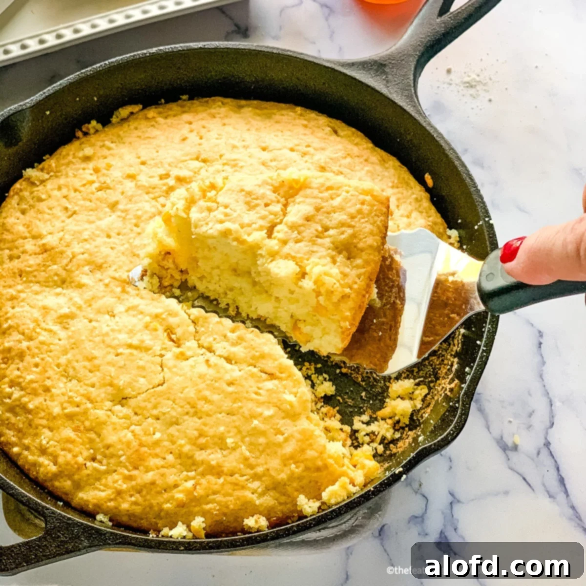 A golden-brown slice of Bisquick Corn Bread, perfect for pairing with soups.