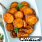 Roasted potato slices in a white serving bowl.