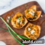 buffalo chicken wonton cups placed in a wooden serving tray.