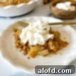 A elegantly plated pear dessert, generously topped with a dollop of fresh whipped cream.