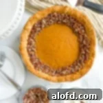 A perfectly baked pumpkin custard pie, topped with a sprinkle of chopped nuts.