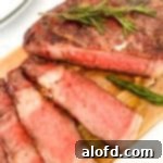 Game Day Grub 23 Sliced cowboy ribeye on a wooden board.