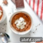 Game Day Grub 43 One small cup of chocolate mousse topped with whipped cream on a white background.