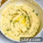 A inviting bowl of creamy garlic and butter mashed potatoes, perfectly smooth and ready to enjoy.