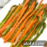 A beautifully arranged plate featuring perfectly roasted carrots and tender asparagus spears.