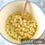 A large, inviting pot brimming with rich white cheddar mac and cheese, ready to be served and enjoyed.