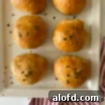 A plate of golden buffalo chicken balls, elegantly topped with fresh parsley for garnish.