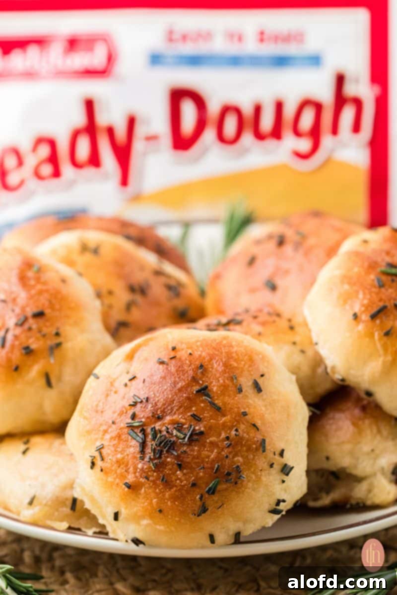 A plate of cheese stuffed dinner rolls with a bag of frozen dough in the background, emphasizing the convenience of the recipe.
