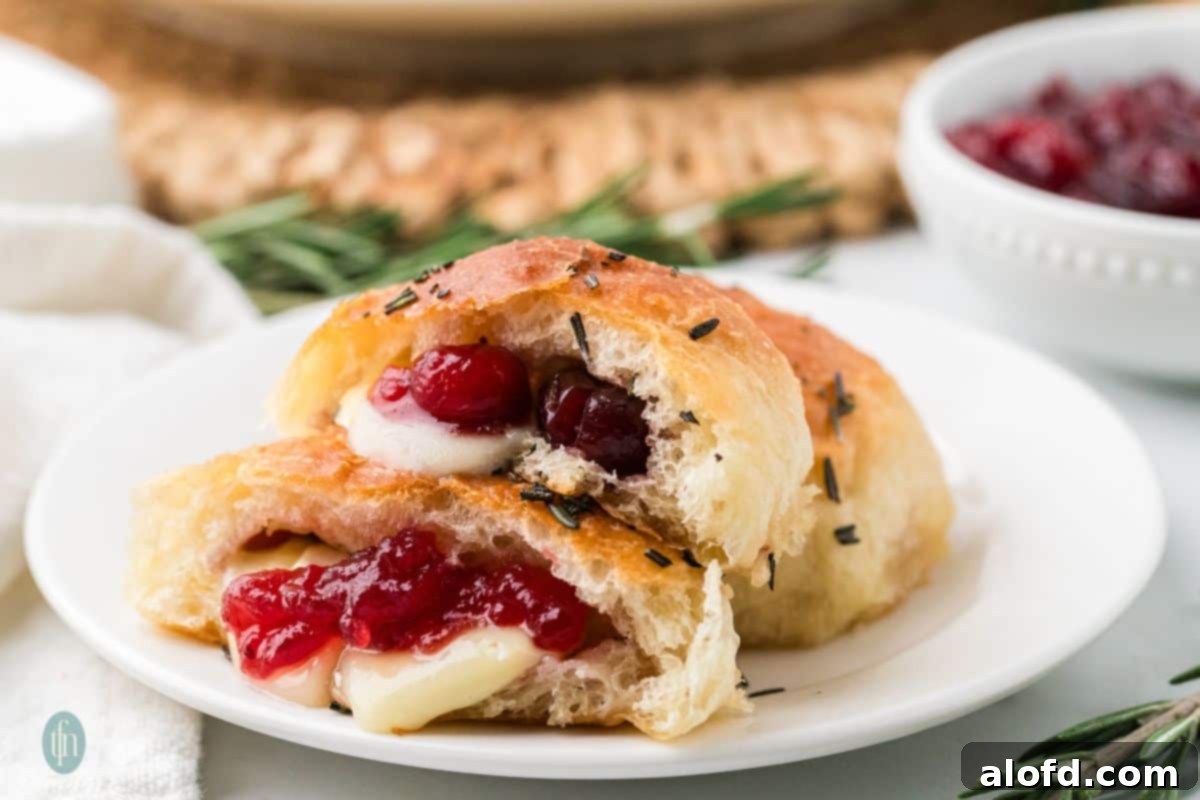 A close-up of a plate of cheese stuffed dinner rolls, showcasing their delicious golden-brown crust.