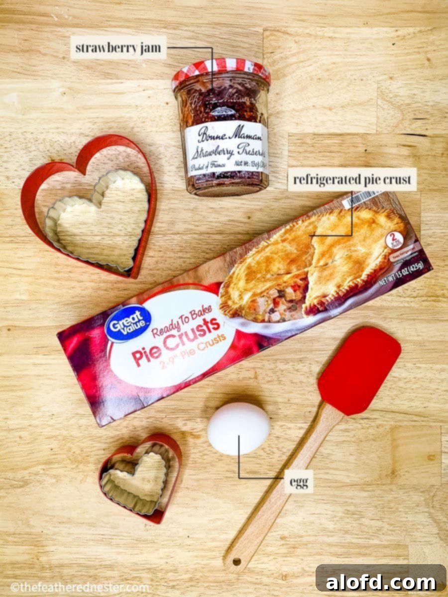 Cupid's Confections 4 Labeled ingredients for making easy heart hand pies, including pie crust, jam, egg, confectioners' sugar, and heavy cream.