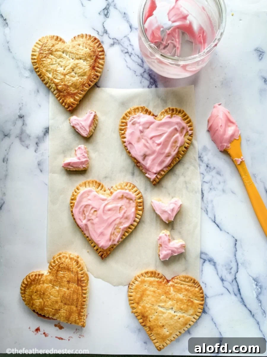 Cupid's Confections 9 Finished Valentine's Day Pop Tarts, frosted and ready to serve.