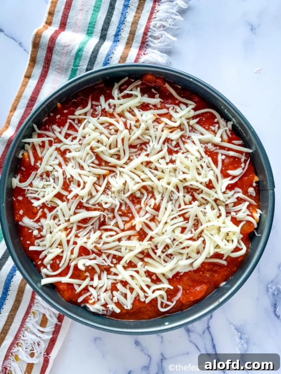 Expertly layered ravioli lasagna in a springform pan, ready for the Instant Pot.