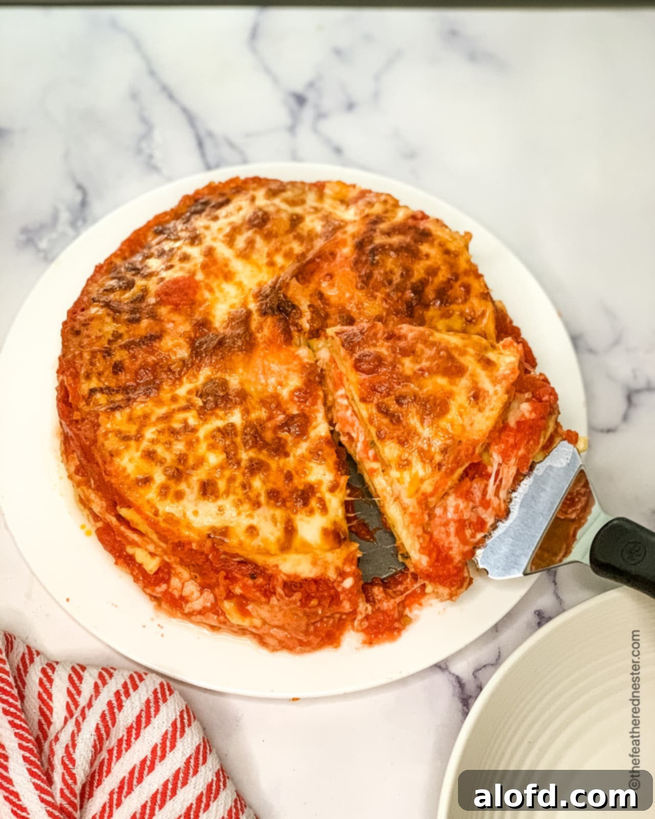 A perfectly cooked slice of Instant Pot ravioli lasagna, ready to be served, showcasing its delicious layers.