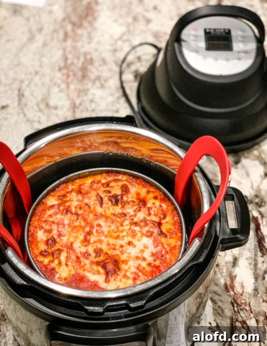 Ravioli lasagna pan inside of Instant Pot, after browning with an air fryer lid, looking perfectly golden.