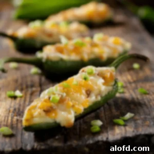 Ultimate Jalapeno Poppers 8 Jalapeno peppers stuffed with cream cheese and cheddar cheese, beautifully arranged.