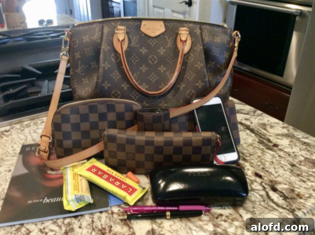 My Life in Handbags: A Passionate History 12 Contents of a Louis Vuitton Turenne bag, showcasing its spacious interior and organization of daily essentials.