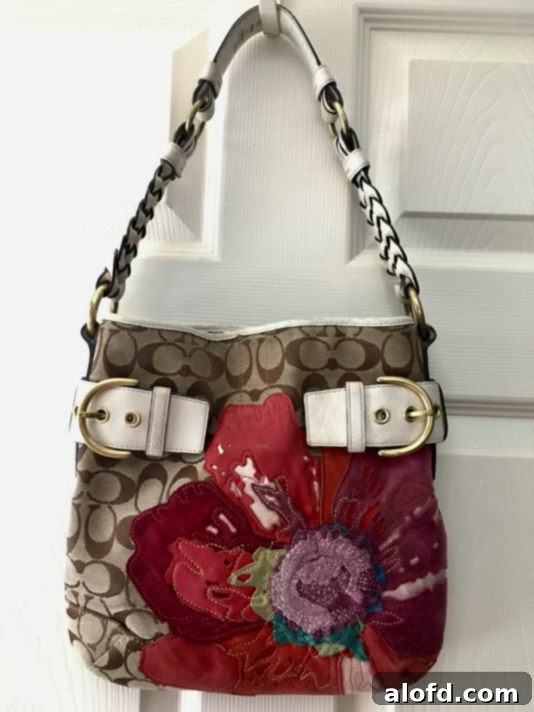 My Life in Handbags: A Passionate History 3 Close-up of a stylish Coach purse with monogram fabric, leather trim, and suede flower details.