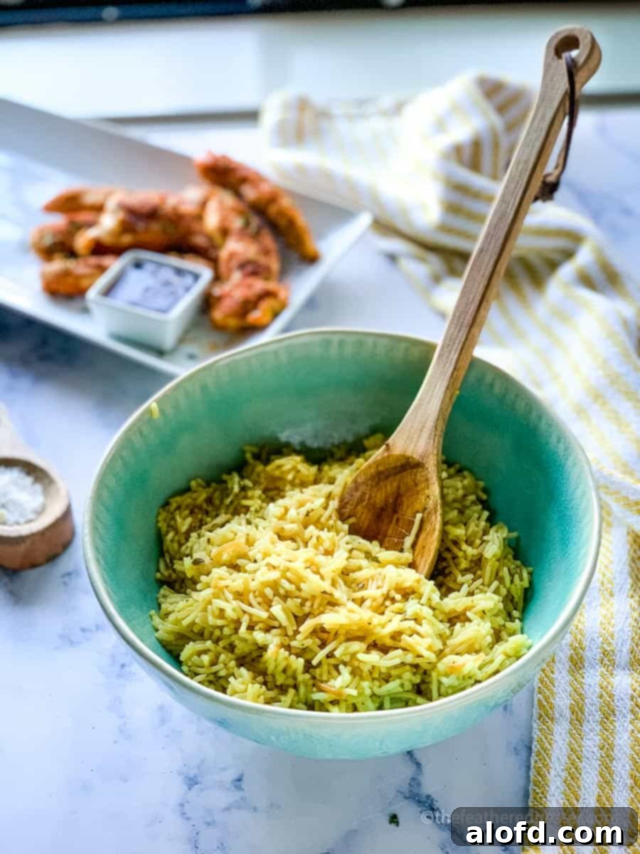 Perfect Instant Pot Rice A Roni 2 Rice A Roni in a green bowl with a platter of chicken in the background instant pot boxed rice.