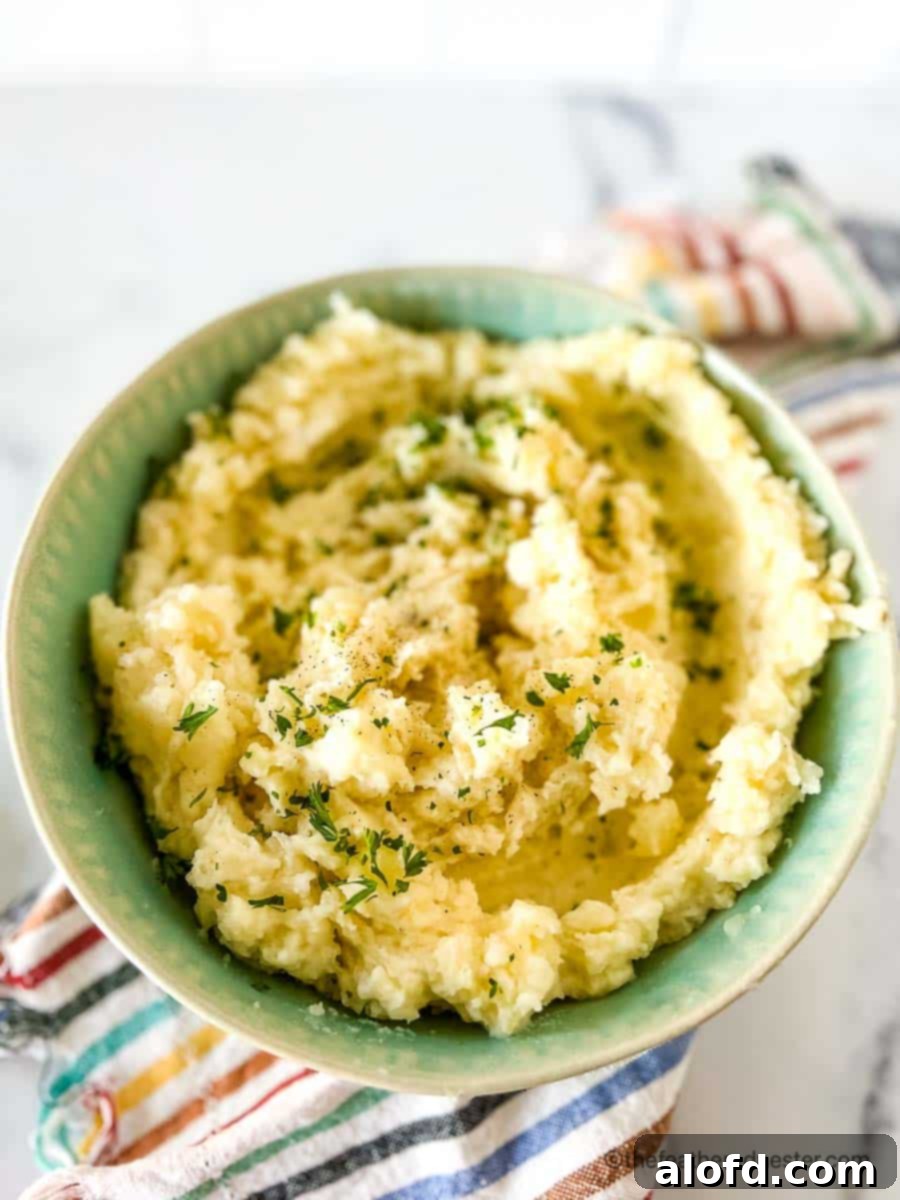 Dreamy Instant Pot Red Potato Mash 3 a green bowl full of potatoes ready to serve.