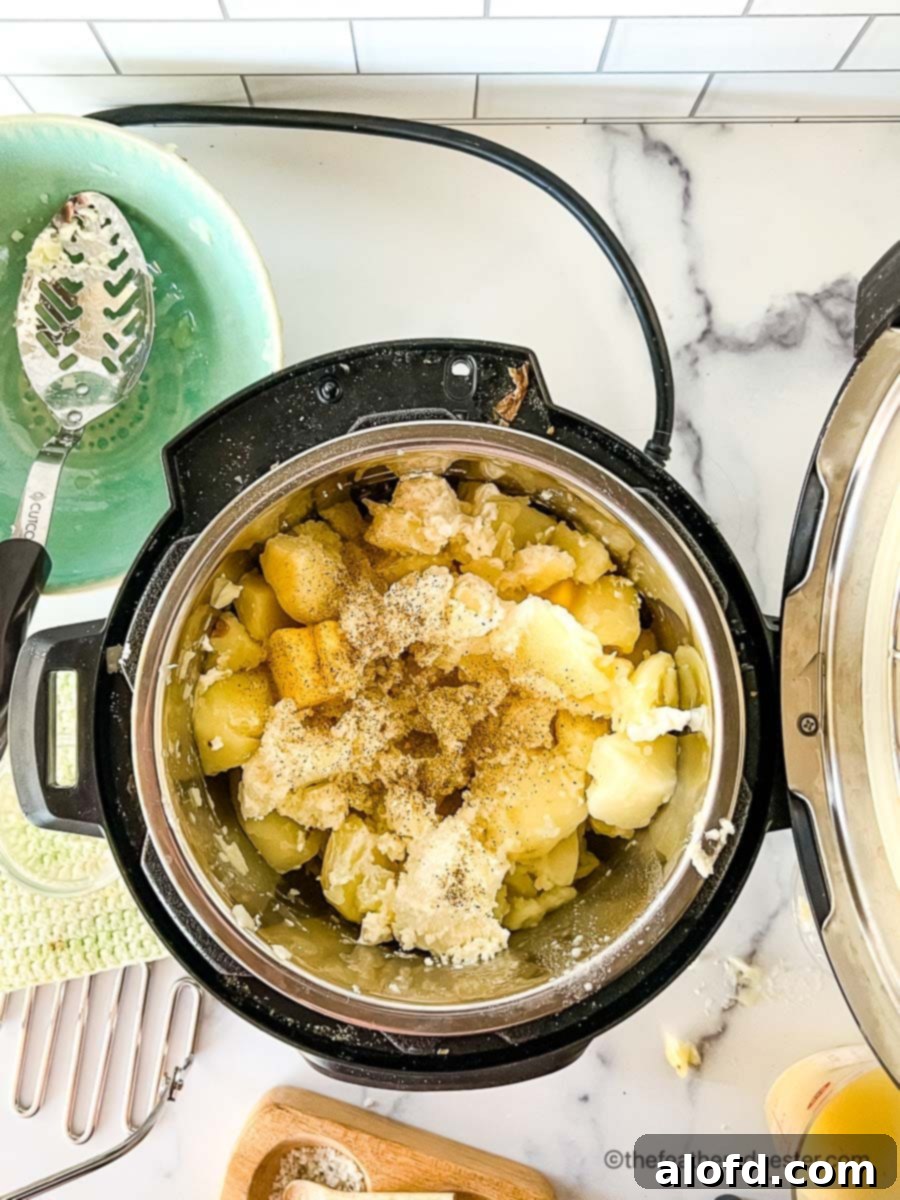 Dreamy Instant Pot Red Potato Mash 8 Mashing red potatoes in an Instant Pot.