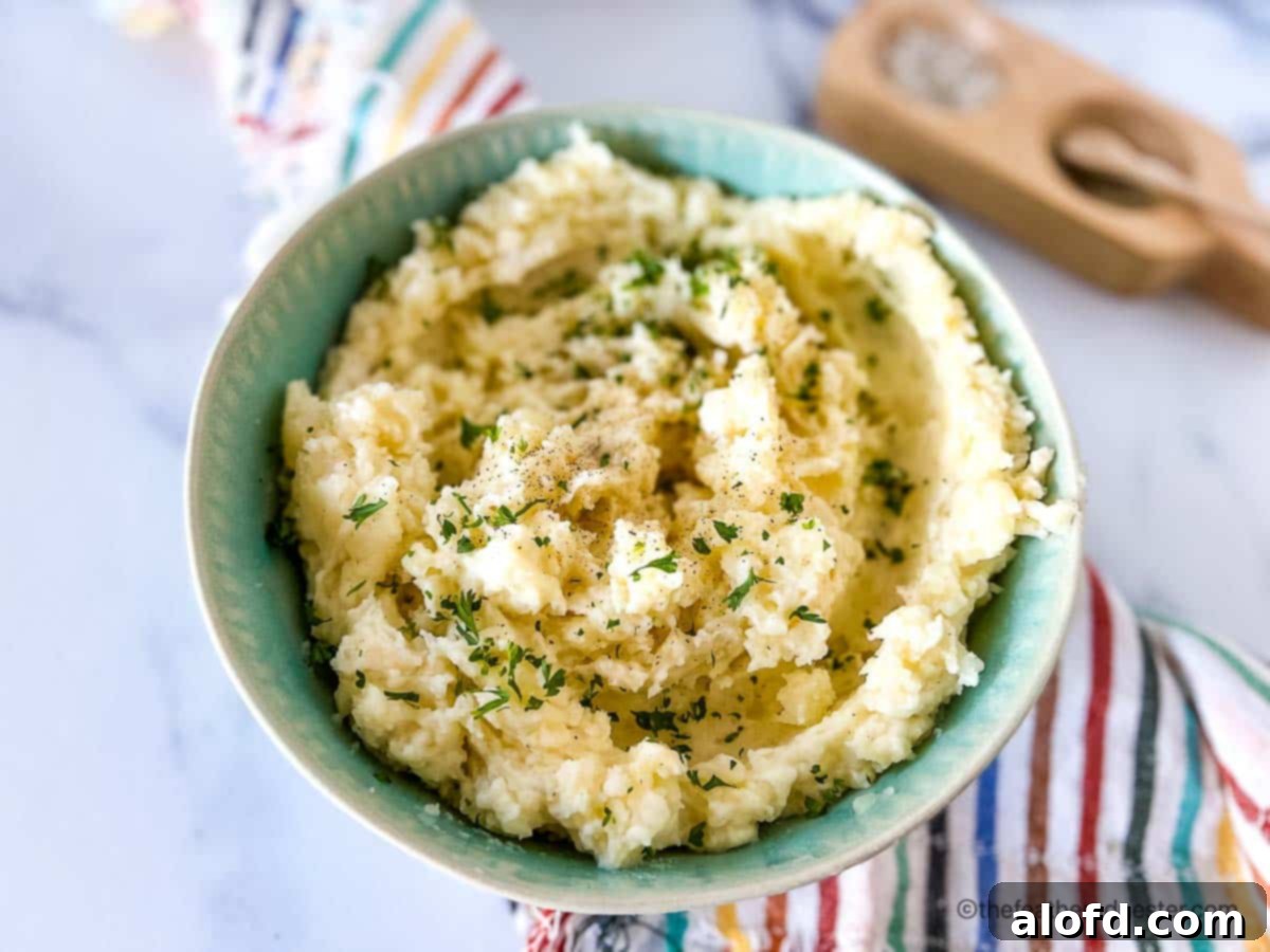 Dreamy Instant Pot Red Potato Mash 10 Red potato side dish in a green serving bowl.