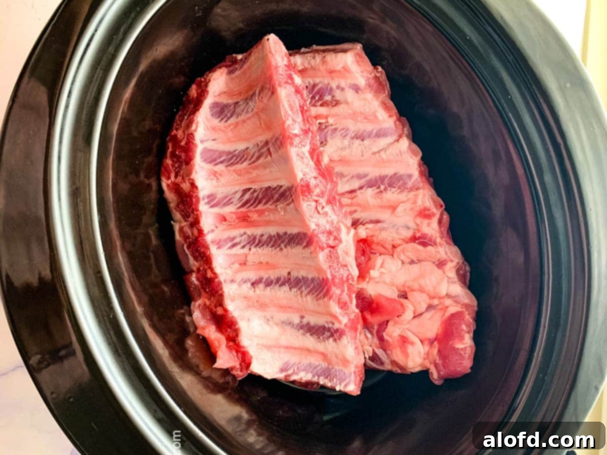 teriyaki ribs shows in the crock pot before basting with sauce
