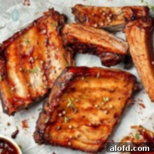 Baby back pork ribs slathered in BBQ sauce.