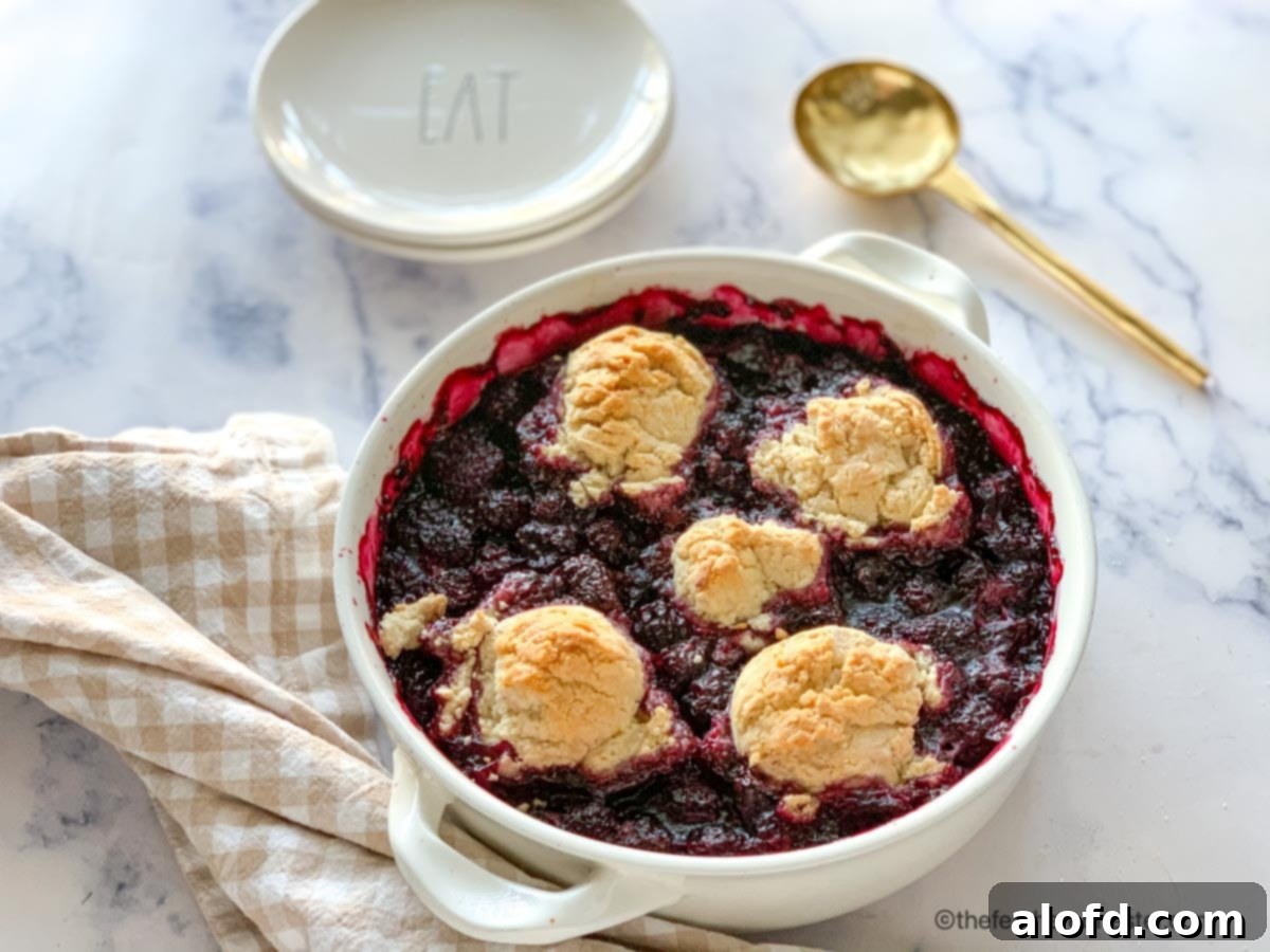Effortless Bisquick Blackberry Bliss 8 Baked Bisquick blackberry cobbler, glistening with fruit and golden topping, ready to serve.