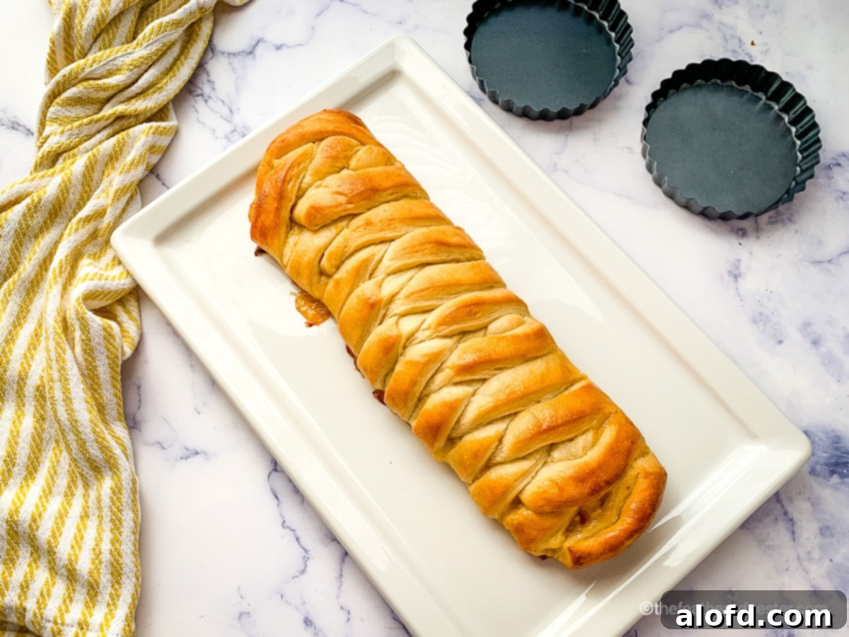 Close-up of a slice of braided lemon bread, showing the layered filling.