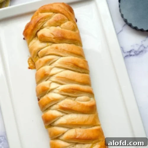 Lemon braided bread loaf on a white platter.