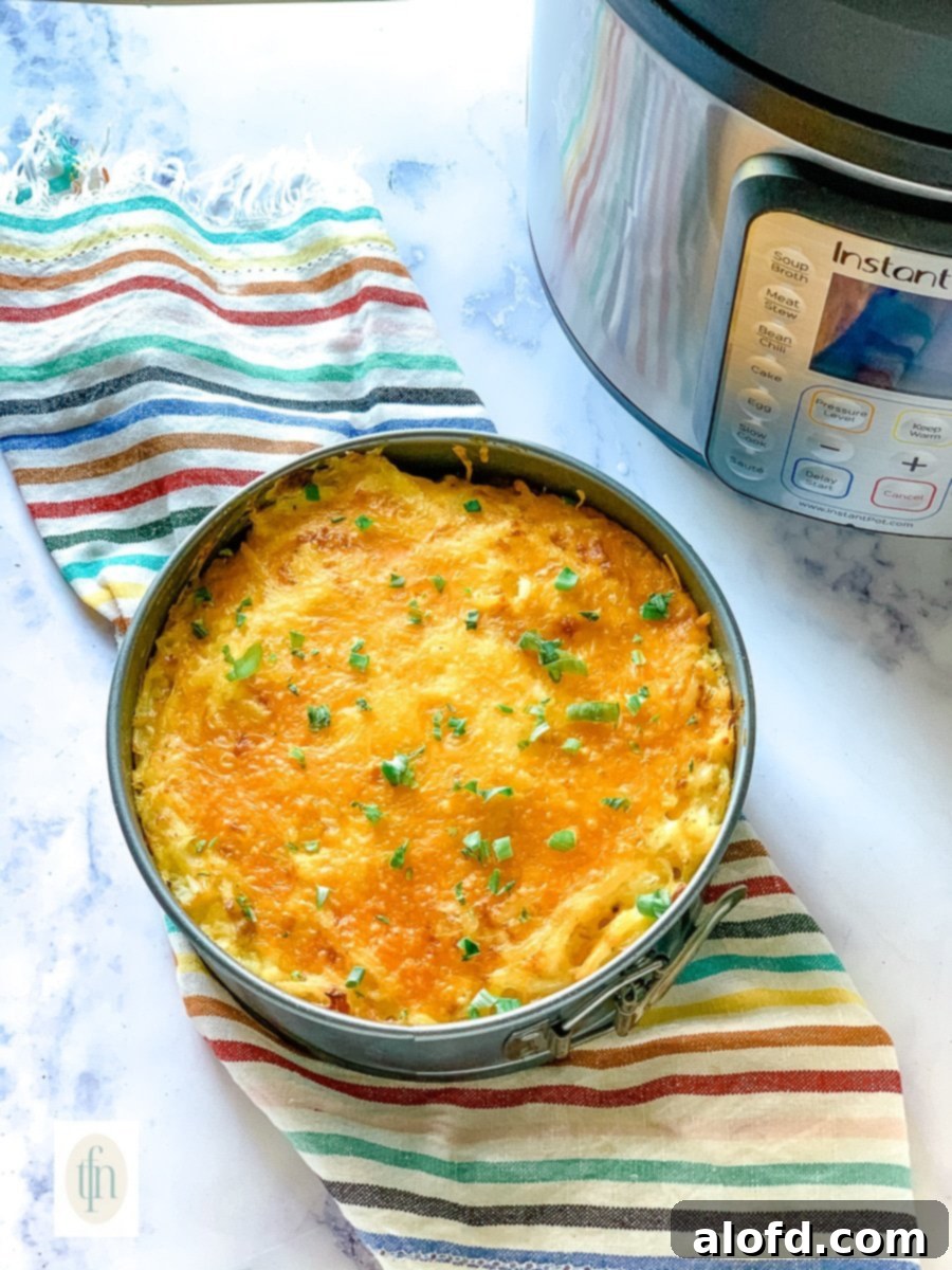 Creamy Instant Pot Cheesy Potatoes 2 Instant Pot hash brown casserole in a springform pan sitting next to an electric pressure cooker.