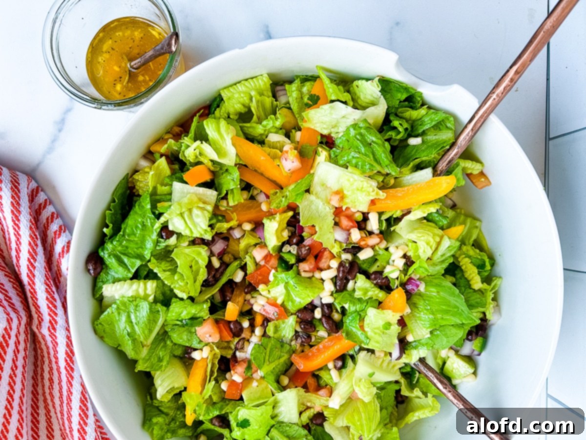 Tossed cowboy salad, vibrant and ready for serving in a large bowl.