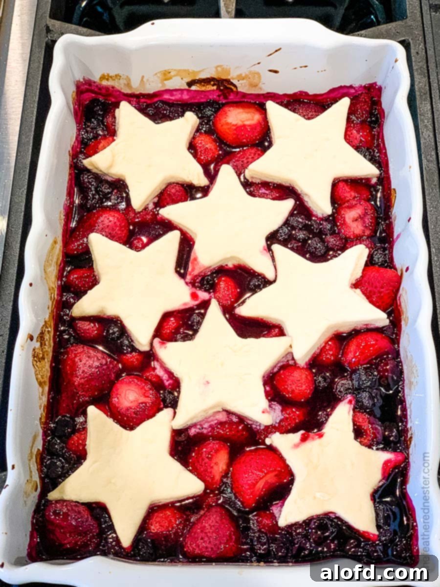 Strawberry blueberry cobbler with star shaped biscuit topping.