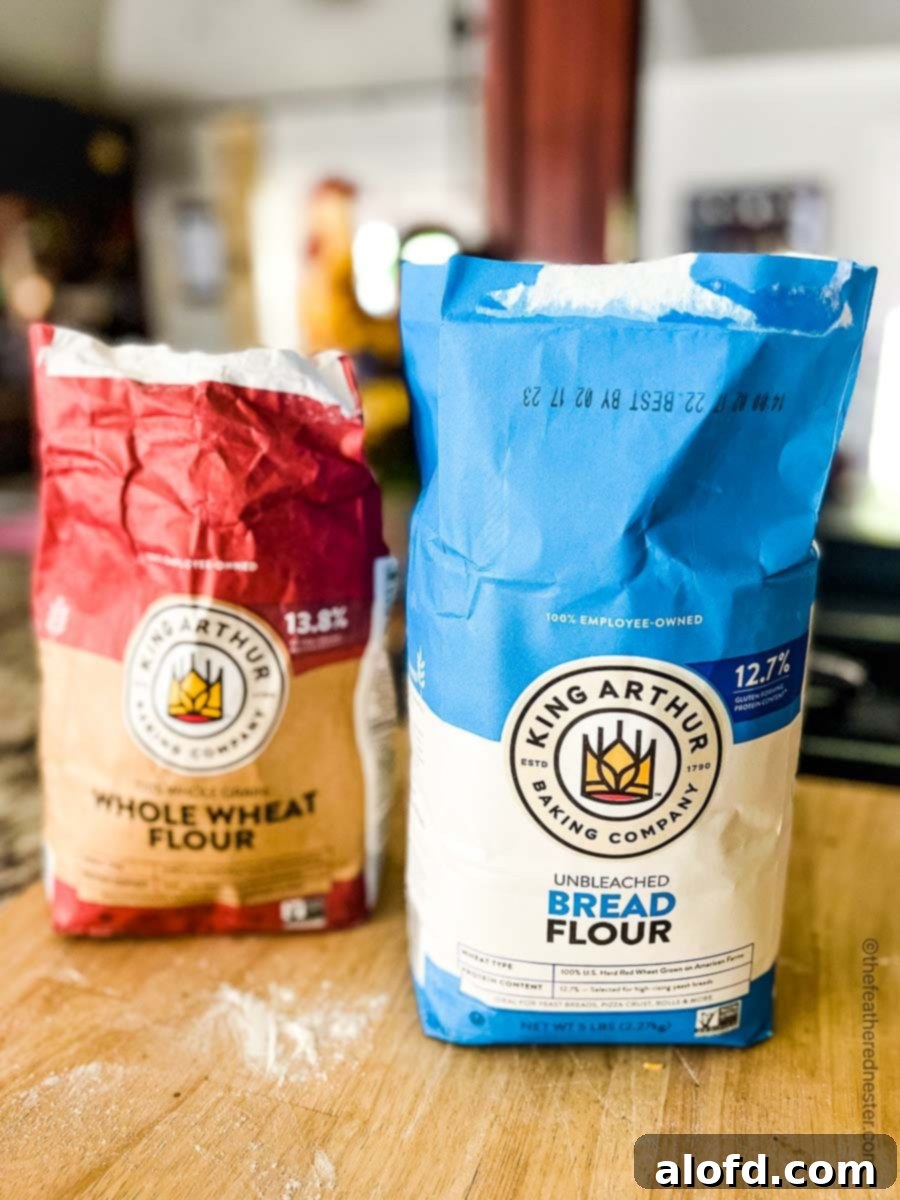 Two bags of King Arthur brand flour, one all-purpose and one bread flour, highlighting recommended brands for sourdough.