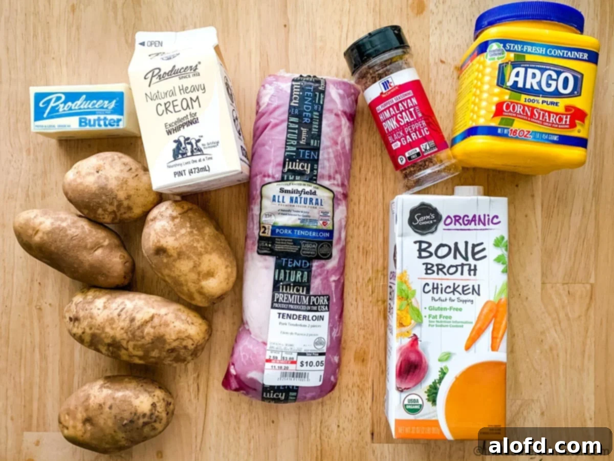 A flat lay of ingredients for instant pot pork tenderloin: chicken broth, potatoes, cream, butter, pork tenderloin, corn starch, and all purpose seasoning.