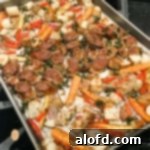 A sheet pan of sausage and mixed vegetables.