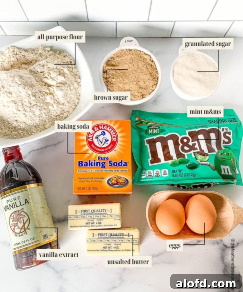 Refreshing Mint Chocolate Indulgence 4 Ingredients laid out on a countertop to make M&M Christmas cookies, including mint-flavored candies, eggs, butter, baking soda, brown sugar, flour, sugar, and vanilla.