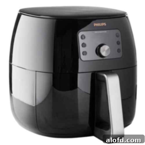 A large, sleek black Philips Premium Digital Smart Sensing Airfryer XXL, illustrating its spacious basket and advanced digital display, ready to deliver crispy, healthy meals to a hungry family.